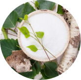 Birch-derived xylitol powder in a wooden bowl